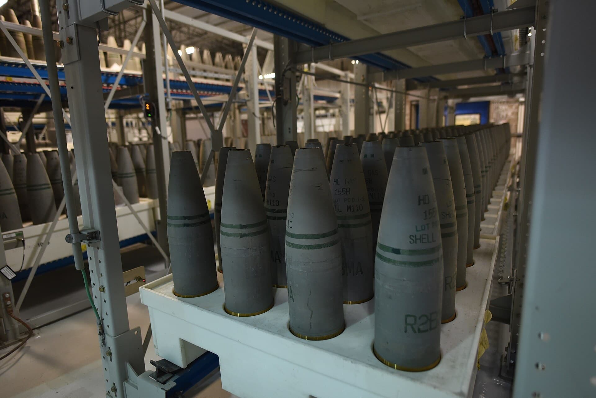 Artillery shells lined up on a production line.